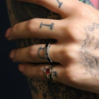 Tattooed hand wearing the silver and black enamel 4mm Til Death band with a red heart Ruby Sempre Ring