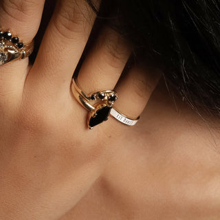 Gold ring with a marquise black stone stacked with the 4mm white enamel Til Death band
