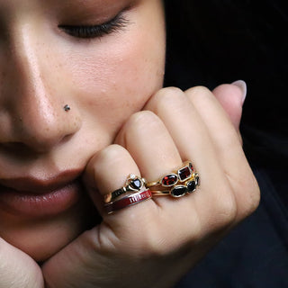 Woman resting her chin on her hands, wearing the silver cherry mocha 4mm Til Death band in a ring stack