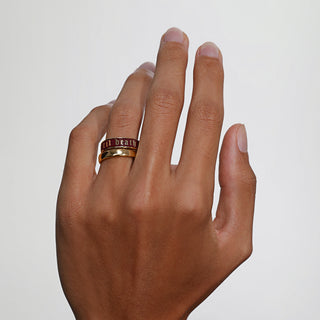 Hand wearing a ring on a plain background