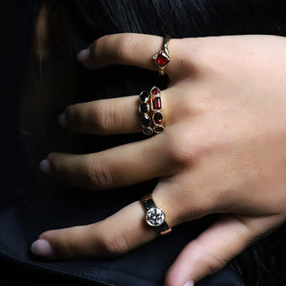 Hand wearing the 0.88ct Ruby Sempre Ring, Garnet Mixed Shape Milgrain Band, Black Diamond Mixed Shape Bezel Band and a round diamond engagement ring