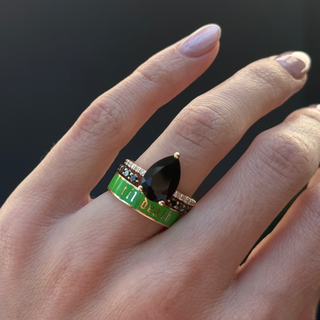 Hand wearing a black onyx ring, stacked with a black diamond band and Scheele's Green "til death" enamel band