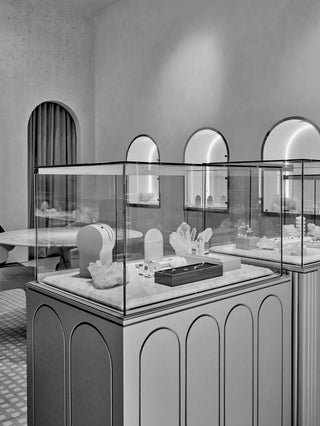 Jewelry display case in a high-end store with elegant interior design.