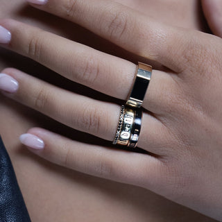 Hand wearing the Til Death Gold Band, 4mm black enamel Til Death band, Black Diamond Whisper band and Elton Enamel Men's Band