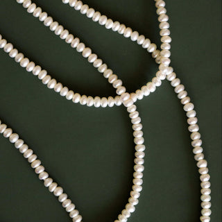 Pearl necklace on a dark green background