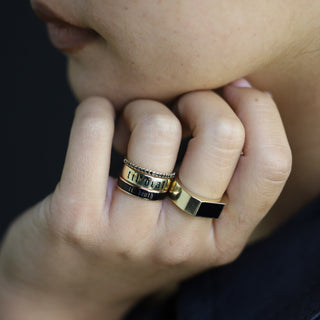 Elton Enamel Men's Band worn with a Til Death band, hand resting near the chin