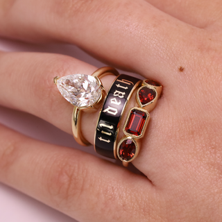 Three rings with different designs on a finger