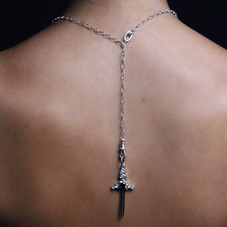Large silver Cross My Heart dagger charm worn on the silver lariat chain