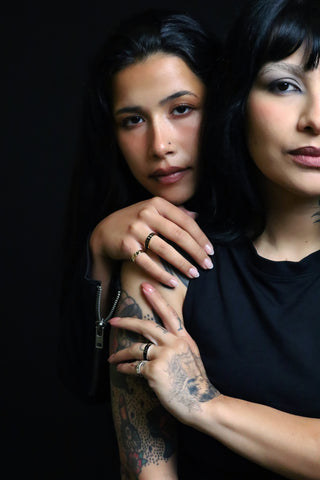 Two women embracing, wearing Til Death World rings