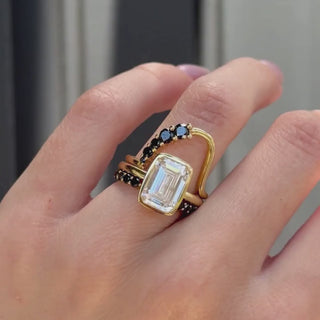 Video of the Black Diamond Lucy Wave Band and Black Diamond Cosmic Light Band stacked with an emerald cut diamond ring on hand