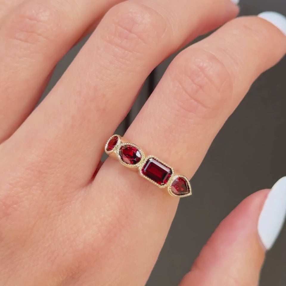 Video of garnet mixed shape milgrain band on hand against a black background
