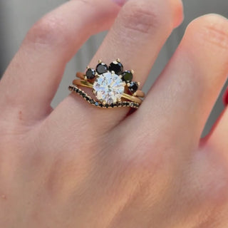 Video of the Curvy Black Diamond Headdress Jacket and Black Diamond Simple Wave Band stacked with a round diamond engagement ring on hand