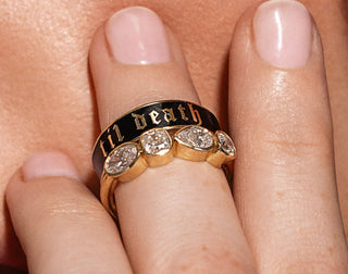 Gold ring with diamonds on a finger