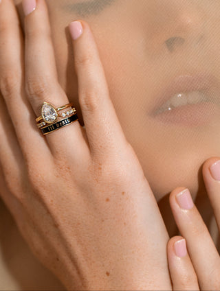 Close-up of a hand with a ring, blurred background